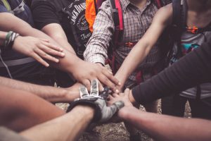 People joining hands creating a sense of community