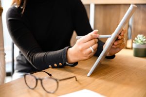 Lady moderating stakeholder comments on a computer